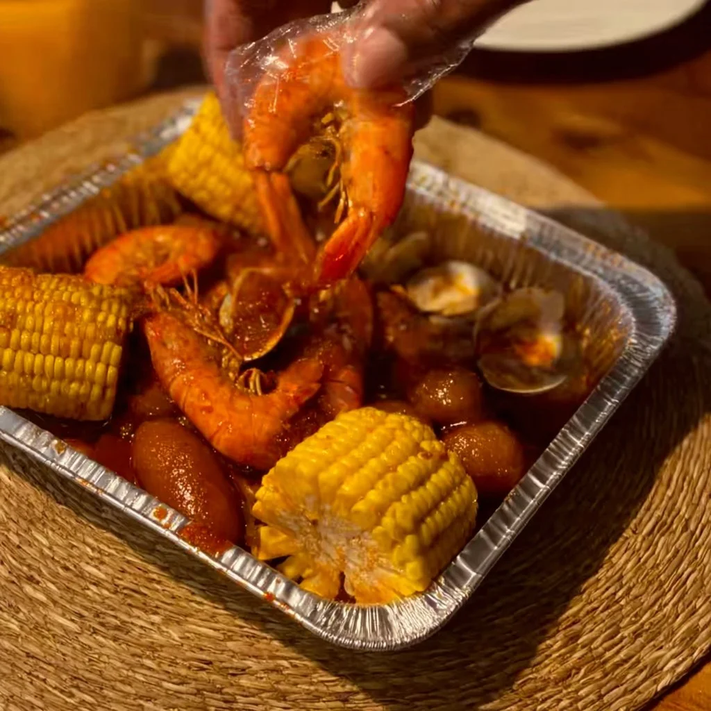 A vibrant seafood boil featuring shrimp, crab, and corn cooked with spices.