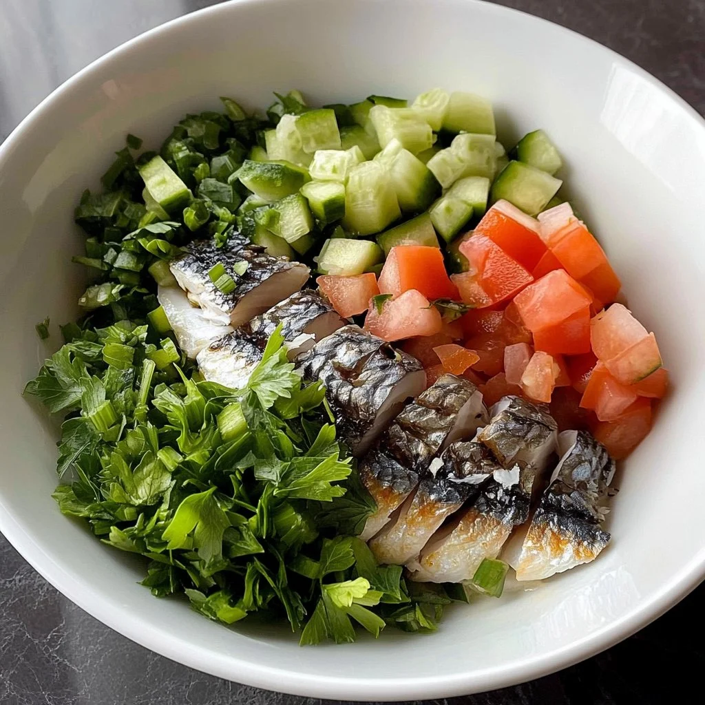 A fresh and vibrant sardine salad with greens, vegetables, and dressing.